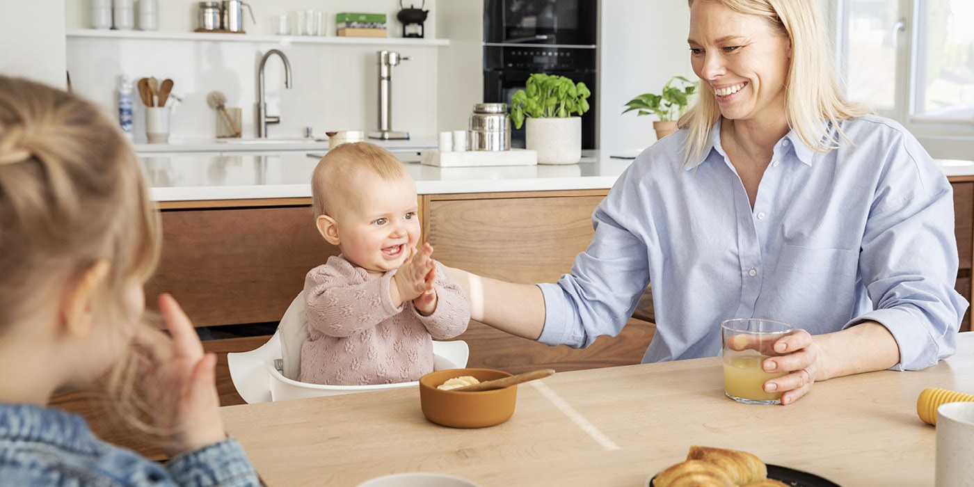 Baby at the table in the Nomi chair with the Baby Set